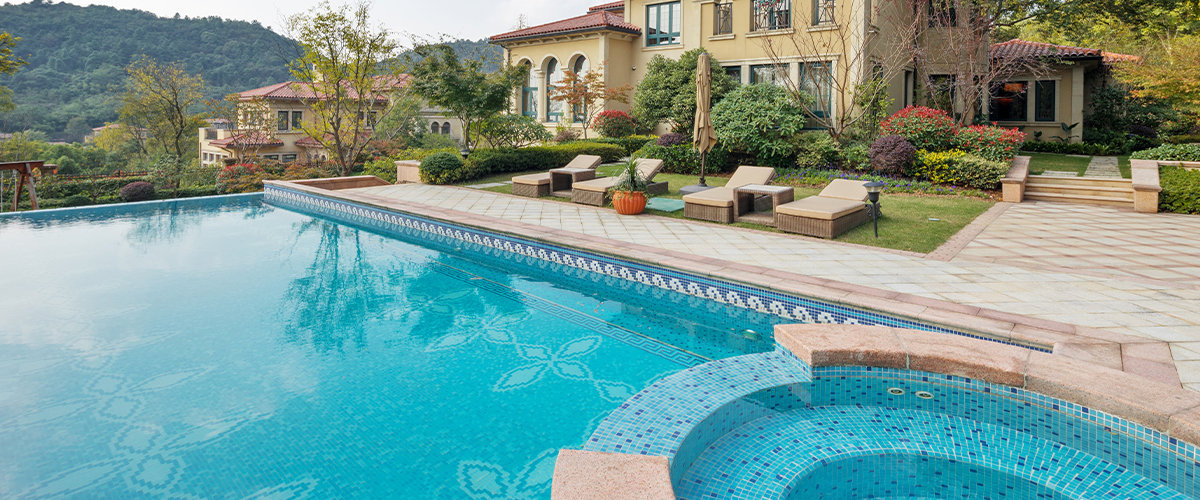 Luxury pool with hot tub waterfall into pool.