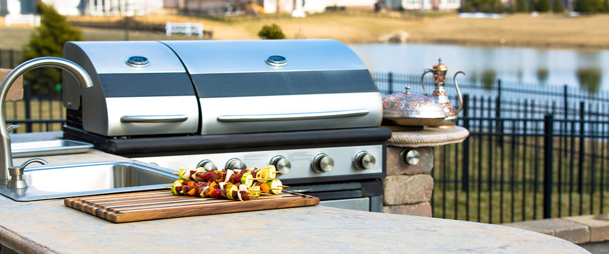 Sink in outdoor kitchen accompanied by a bbq